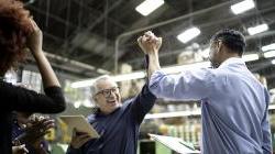 Employee team celebrating together in warehouse