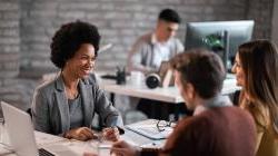 Bank representative working with couple reviewing documents