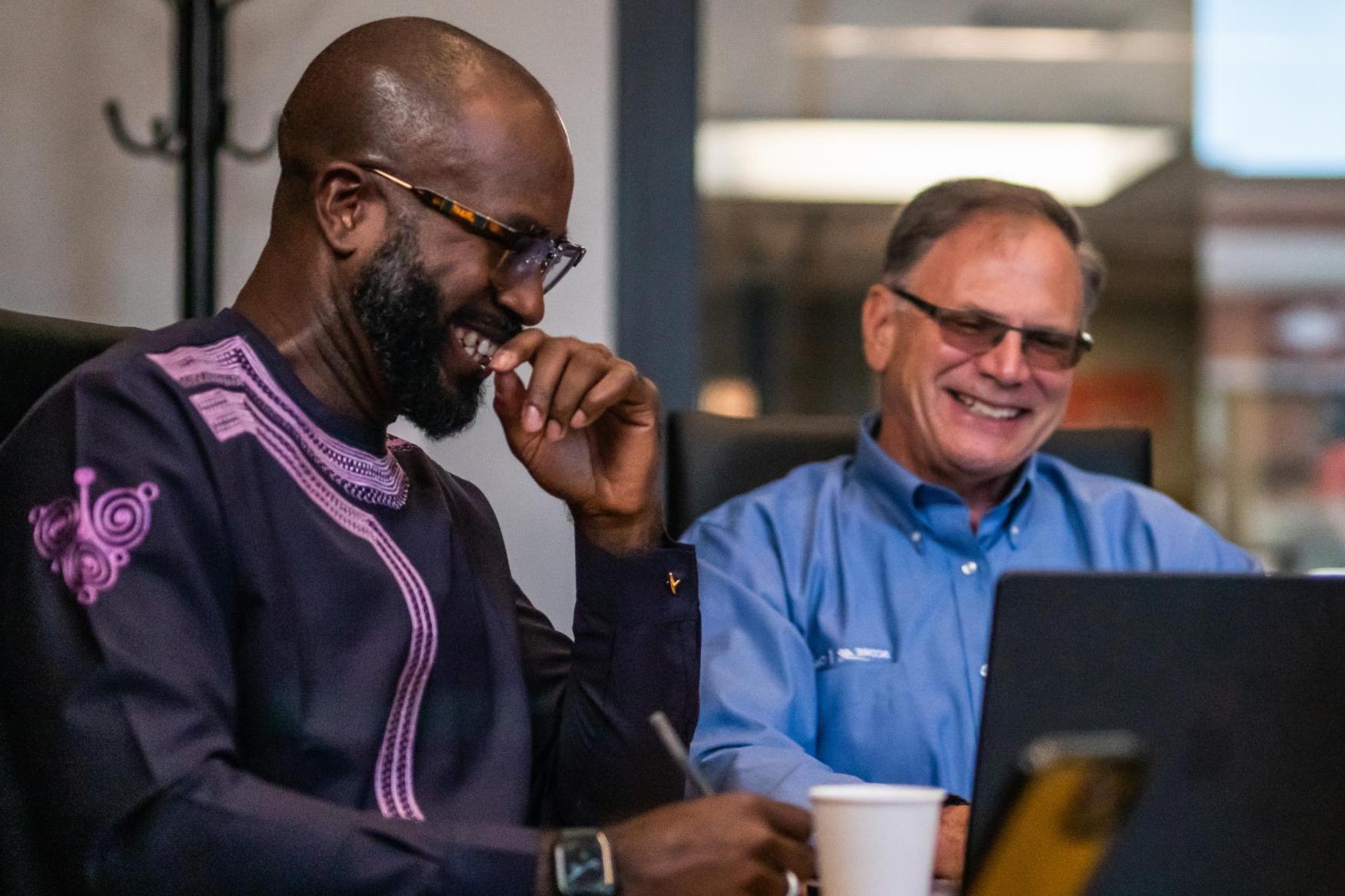 SCORE client Iyobosa Ero (right) developed the Chicago-based online travel solution Preparture with support from SCORE mentor Steven Lome.